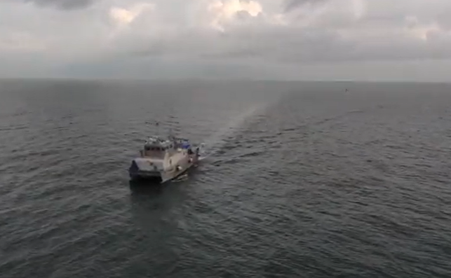 Ship in the ocean with cloudy sky