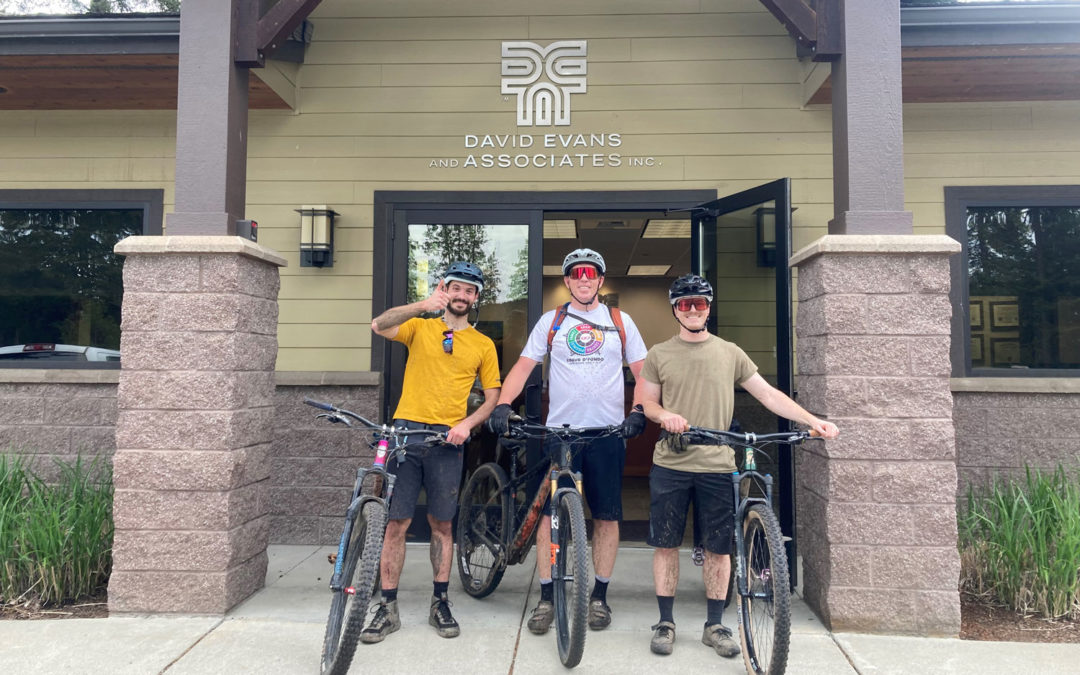 Three people on bikes in front of Coeur d'Alene office