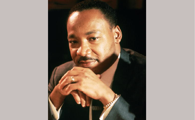 Martin Luther King Jr. headshot with hands crossed in front of face